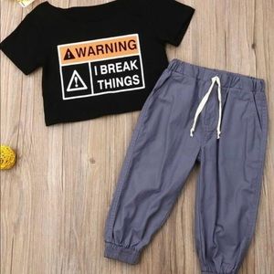 Black hang off the shoulder black T-shirt with grey pants